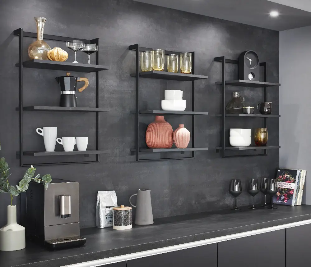 Kitchenwall with artworks standing on shelves Kitchenwall with artworks standing on shelves