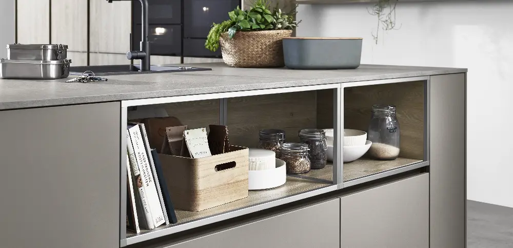 Open shelves which are located under the worktop as part of the kitchen island filled with Artworks and decor Open shelves which are located under the worktop as part of the kitchen island filled with Artworks and decor