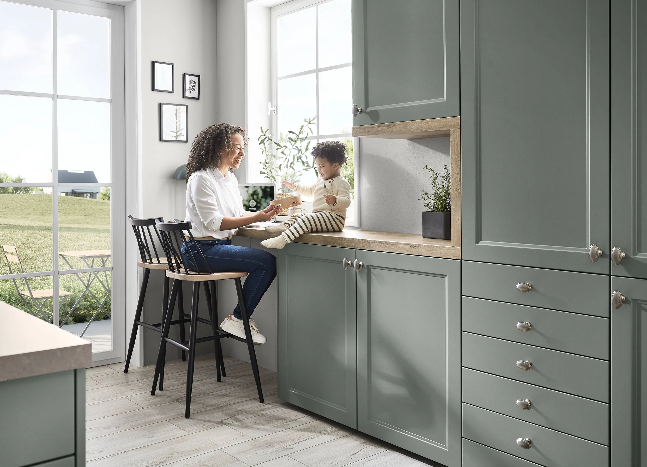 Mother and child in an ergonomic kitchen with sage green cabinets and a cosy seating area, designed for comfort and hygiene with family-friendly elements. Mother and child in an ergonomic kitchen with sage green cabinets and a cosy seating area, designed for comfort and hygiene with family-friendly elements.