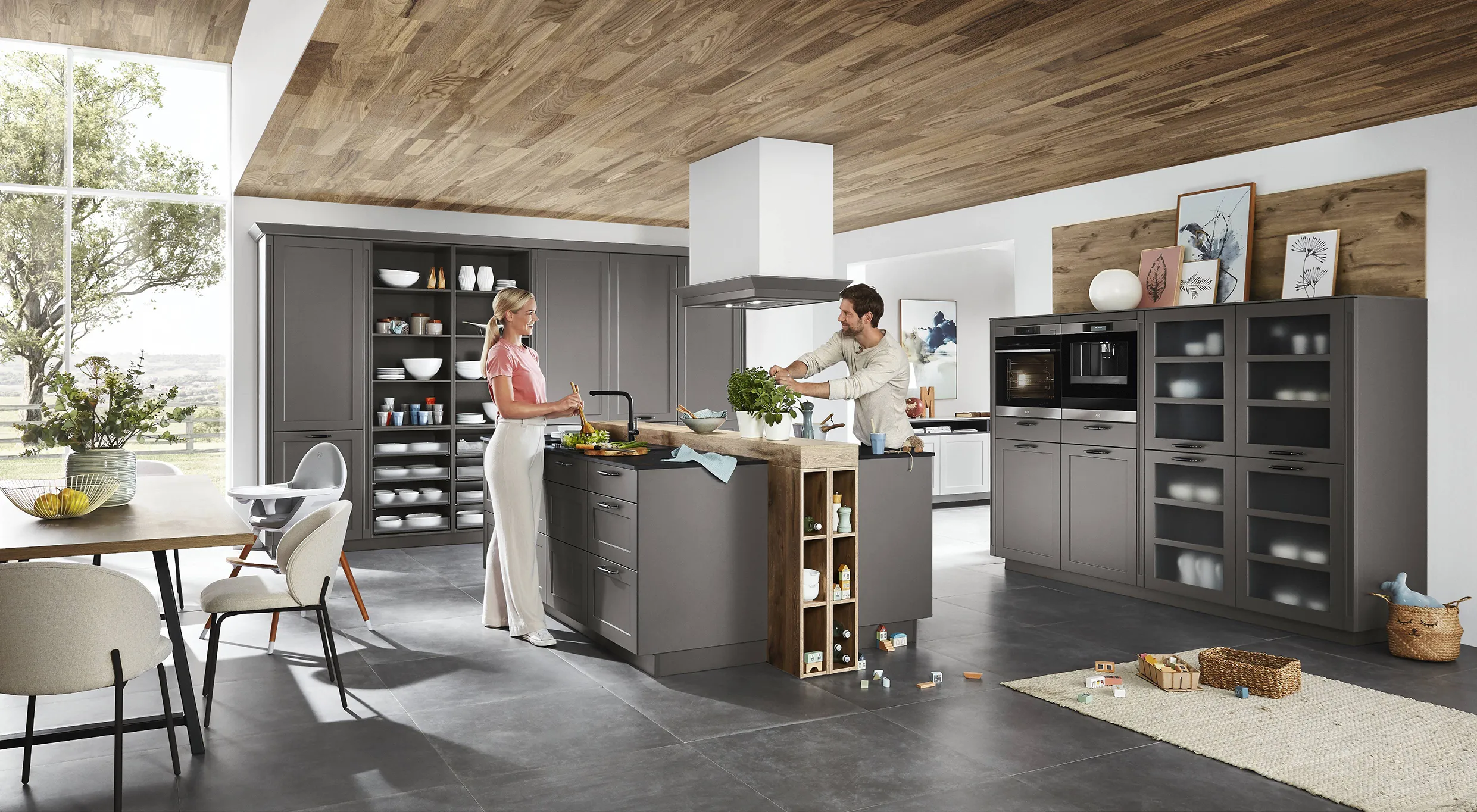 Couple preparing food in a modern kitchen with dark cabinets, glass-front storage, and wood accents, showcasing popular cabinet design trends. Couple preparing food in a modern kitchen with dark cabinets, glass-front storage, and wood accents, showcasing popular cabinet design trends.