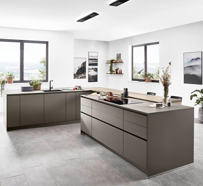 Modern grey kitchen showcasing a large island and a stylish sink  Modern grey kitchen showcasing a large island and a stylish sink