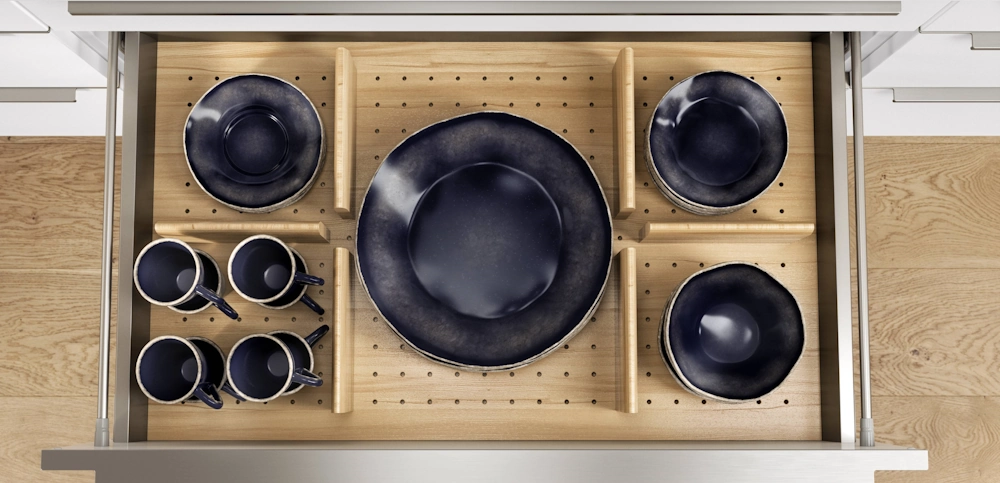 Pulled out drawer with black tableware inside Pulled out drawer with black tableware inside