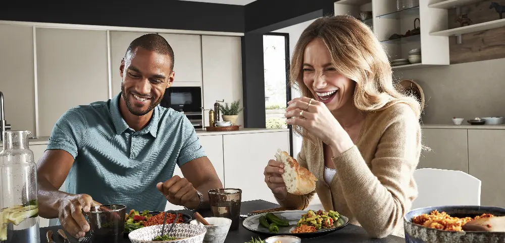 couple laughing while eating couple laughing while eating