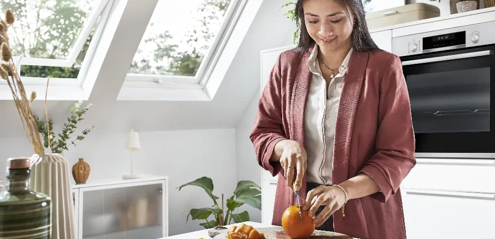 woman cutting oranges in a feng shui styled kitchen woman cutting oranges in a feng shui styled kitchen